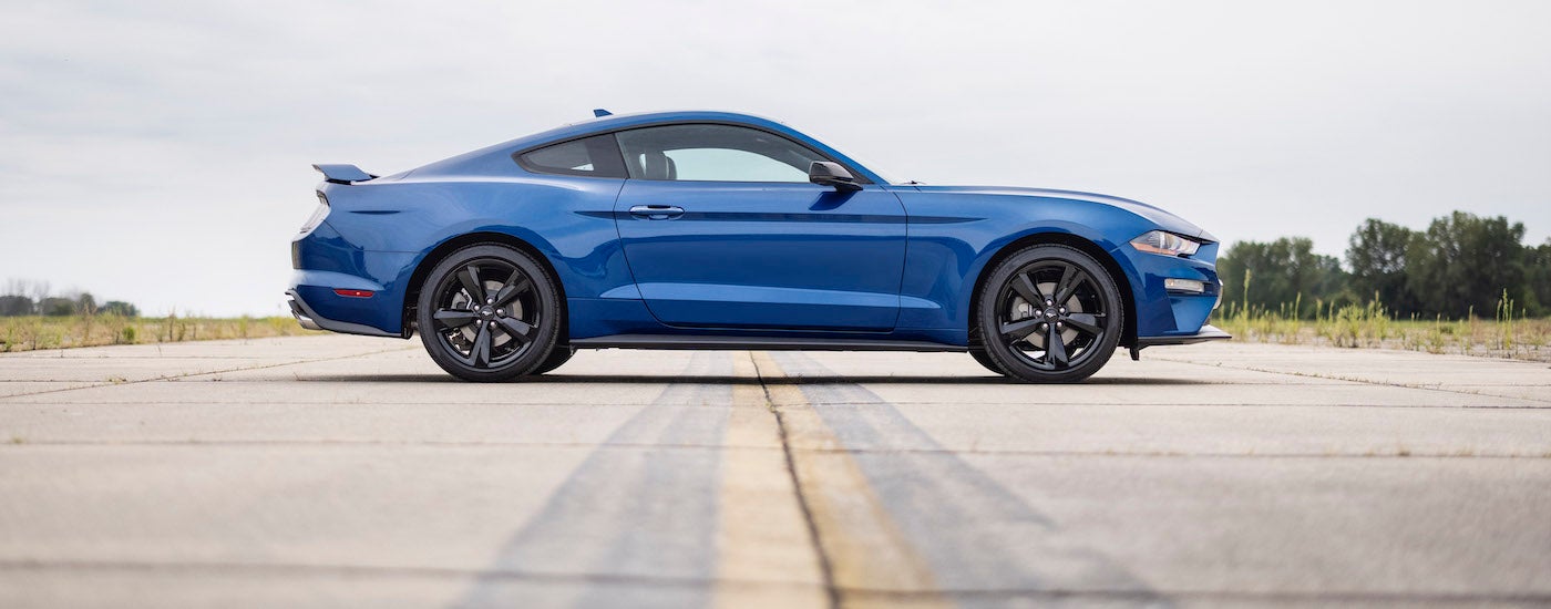 A blue 2022 Ford Mustang is shown from the side.