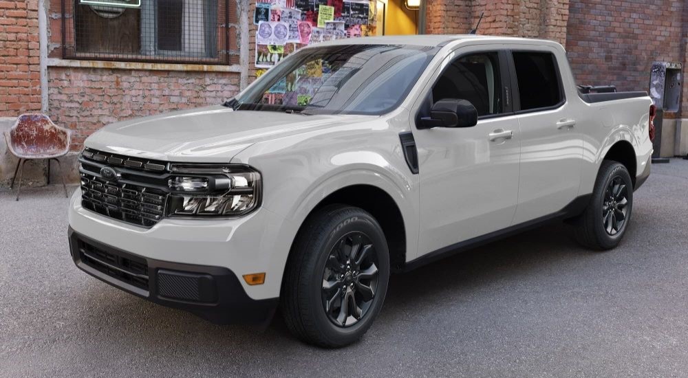 A white 2023 Ford Maverick Lariat parked in a garage.