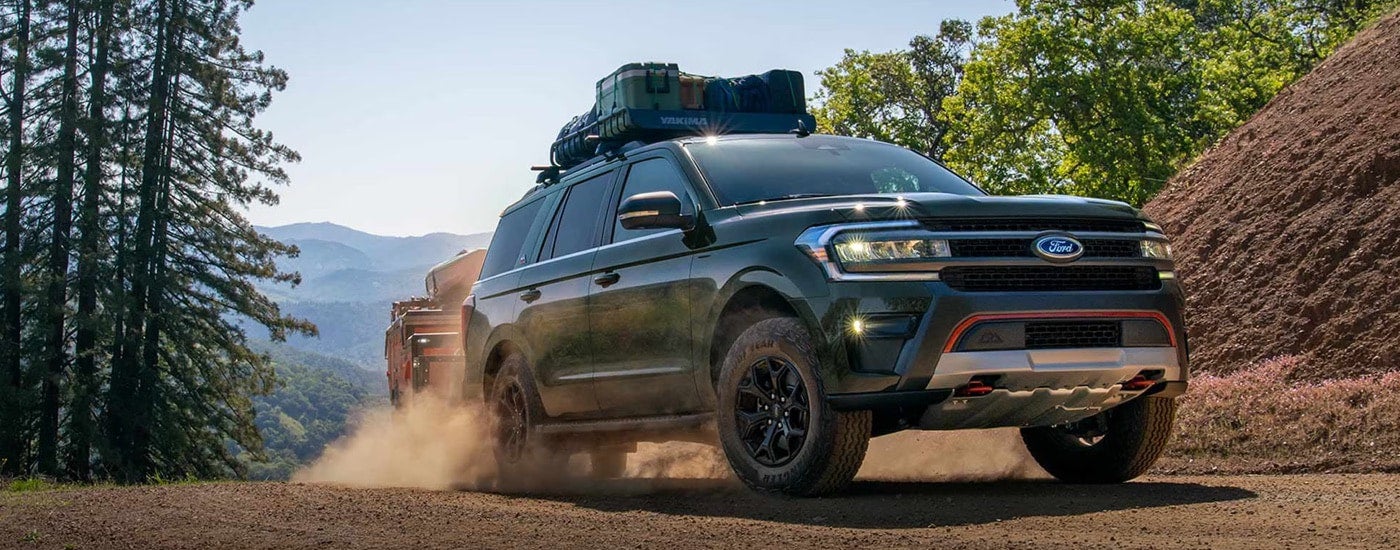 A green 2024 Ford Expedition Timberline hauling cargo while off-roading.
